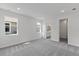 Neutral bedroom with plush carpet, two windows, and an ensuite bathroom entrance at 9584 Vibrant Lane, Venice, FL 34292