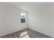 Carpeted bedroom featuring a window with a view, white walls, and electrical outlets at 9584 Vibrant Lane, Venice, FL 34292