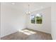 Dining area with a chandelier fixture and a large window with view to a green backyard at 9584 Vibrant Lane, Venice, FL 34292