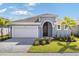 Charming one-story home with a well-manicured lawn, paver driveway, and welcoming entryway at 9584 Vibrant Lane, Venice, FL 34292