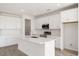 Bright kitchen featuring white cabinets, stainless steel appliances, and a large island at 9584 Vibrant Lane, Venice, FL 34292
