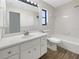 Bathroom featuring tiled walls, modern fixtures, and a shower-tub combination at 7087 Spinnaker Blvd, Englewood, FL 34224