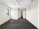 A bright and spacious bedroom featuring plush carpeting, a ceiling fan, and a walk-in closet, offering ample storage space at 7087 Spinnaker Blvd, Englewood, FL 34224