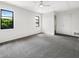 Bright bedroom with ample natural light, featuring plush carpeting and a ceiling fan at 7087 Spinnaker Blvd, Englewood, FL 34224
