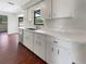 Bright kitchen featuring white cabinetry, stainless steel appliances, and modern countertops at 7087 Spinnaker Blvd, Englewood, FL 34224
