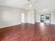 Spacious living room featuring hardwood floors and ample natural light, flowing seamlessly into the kitchen area at 7087 Spinnaker Blvd, Englewood, FL 34224