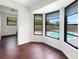 Inviting living room with a bay window showcasing a view of the refreshing outdoor pool at 7087 Spinnaker Blvd, Englewood, FL 34224