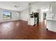 Open-concept living area flowing into the kitchen, featuring hardwood floors and lots of natural light at 7087 Spinnaker Blvd, Englewood, FL 34224