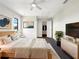 Cozy primary bedroom showcasing a queen-sized bed, stylish decor, ceiling fan, and a convenient walk-in closet at 7087 Spinnaker Blvd, Englewood, FL 34224