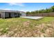 A backyard featuring a refreshing in-ground swimming pool, grassy areas, and a privacy fence, perfect for outdoor enjoyment at 7087 Spinnaker Blvd, Englewood, FL 34224