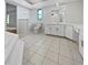 Modern bathroom featuring tile floors, a shower, a bathtub, and white cabinets at 3524 Cessna St, Port Charlotte, FL 33948