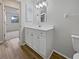 Bathroom vanity featuring lots of storage, wood floors, and view to the hall and bedroom at 3524 Cessna St, Port Charlotte, FL 33948