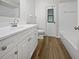 Updated bathroom with a big mirror, vanity, wood-style floors, and a shower/tub combo at 3524 Cessna St, Port Charlotte, FL 33948
