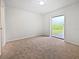 Bright bedroom featuring neutral carpet and large window, offering natural light at 3524 Cessna St, Port Charlotte, FL 33948