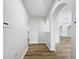 Hallway with wood-look flooring and arched entries at 3524 Cessna St, Port Charlotte, FL 33948