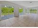 Expansive sunroom boasting tiled floors, patio access and peaceful backyard views at 3524 Cessna St, Port Charlotte, FL 33948