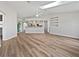 Open-concept living room with stylish flooring, skylight, and seamless flow into the kitchen at 3524 Cessna St, Port Charlotte, FL 33948