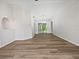 Spacious room with wood floors, white walls and trim, and a glass slider leading to the outside at 3524 Cessna St, Port Charlotte, FL 33948