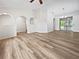 Spacious living room with vaulted ceilings, wood-look flooring, and sliding glass doors at 3524 Cessna St, Port Charlotte, FL 33948