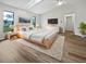 Bright main bedroom featuring a ceiling fan, a skylight, and wood-look flooring at 3524 Cessna St, Port Charlotte, FL 33948