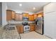 Modern kitchen with light wood cabinets and stainless steel appliances at 20453 Berrywood Ln, Tampa, FL 33647