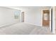 Spacious bedroom with carpet flooring and hallway access at 7628 Intrepid Rd, Wesley Chapel, FL 33545