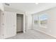 Upstairs bedroom with carpet, closet, and window at 7628 Intrepid Rd, Wesley Chapel, FL 33545