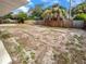 Large backyard features wood privacy fence, lush trees, and gravel ground cover at 4409 W Leila Ave, Tampa, FL 33616