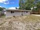Home's exterior displays new siding, fenced yard, and gravel ground cover in the backyard at 4409 W Leila Ave, Tampa, FL 33616