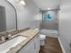 Updated bathroom features granite countertop, new fixtures, and a shower-over-tub combination at 4409 W Leila Ave, Tampa, FL 33616
