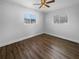 This bedroom offers wood-look flooring, two large windows, fresh paint, and neutral finishes at 4409 W Leila Ave, Tampa, FL 33616