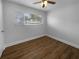 Neutral bedroom with updated flooring, ceiling fan, and natural light through the window at 4409 W Leila Ave, Tampa, FL 33616