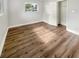 Bright bedroom features wood-look flooring, white trim, window letting in natural light, and a closet at 4409 W Leila Ave, Tampa, FL 33616