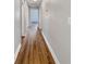 Hallway with updated flooring and neutral paint, providing access to various rooms at 4409 W Leila Ave, Tampa, FL 33616