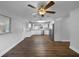 Bright kitchen features stainless appliances, white cabinets, granite counters, and wood floors at 4409 W Leila Ave, Tampa, FL 33616