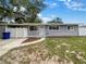 Newly renovated light purple house with a fenced yard at 4409 W Leila Ave, Tampa, FL 33616