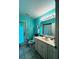 Charming bathroom with teal walls and a white vanity at 4202 Perch Cir, Port Charlotte, FL 33948