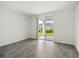 Bright bedroom with neutral walls and carpet, featuring a sliding door closet at 428 Lazy Shore Dr, Nokomis, FL 34275