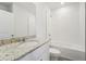 Clean bathroom with granite countertop, bathtub, and shower at 428 Lazy Shore Dr, Nokomis, FL 34275