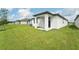 Backyard with covered patio and grassy area at 428 Lazy Shore Dr, Nokomis, FL 34275