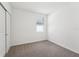 Simple bedroom with neutral walls and carpet, featuring a sliding door closet and window at 428 Lazy Shore Dr, Nokomis, FL 34275