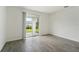 Bright bedroom with gray tile floors and sliding glass door to backyard at 428 Lazy Shore Dr, Nokomis, FL 34275