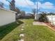 Spacious backyard with green lawn and stepping stones at 548 47Th N Ave, St Petersburg, FL 33703