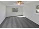 A clean and spacious bedroom featuring gray carpet, two windows and ceiling fan at 548 47Th N Ave, St Petersburg, FL 33703