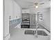 Modern kitchen featuring stainless steel appliances, white cabinets, quartz countertops, and stylish backsplash at 548 47Th N Ave, St Petersburg, FL 33703
