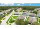 Aerial view of a neighborhood with various houses and a lake at 19056 Chislehurst Dr, Land O Lakes, FL 34638