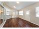 Sunroom with wood flooring, sliding doors, and abundant natural light at 1090 Yarmouth St, Port Charlotte, FL 33952