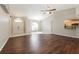 Bright living room with tile and wood flooring, high ceilings, and access to kitchen at 1090 Yarmouth St, Port Charlotte, FL 33952