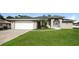 One-story house with a spacious lawn and attached garage at 1090 Yarmouth St, Port Charlotte, FL 33952