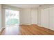 Bedroom with hardwood floors, sliding door to backyard, and double door closet at 1090 Yarmouth St, Port Charlotte, FL 33952
